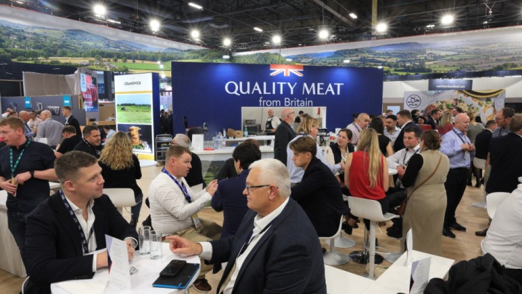 People sitting at tables at a trade event.